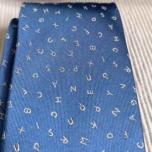 Tie Joseph Abboud silk lt blue - letters on it